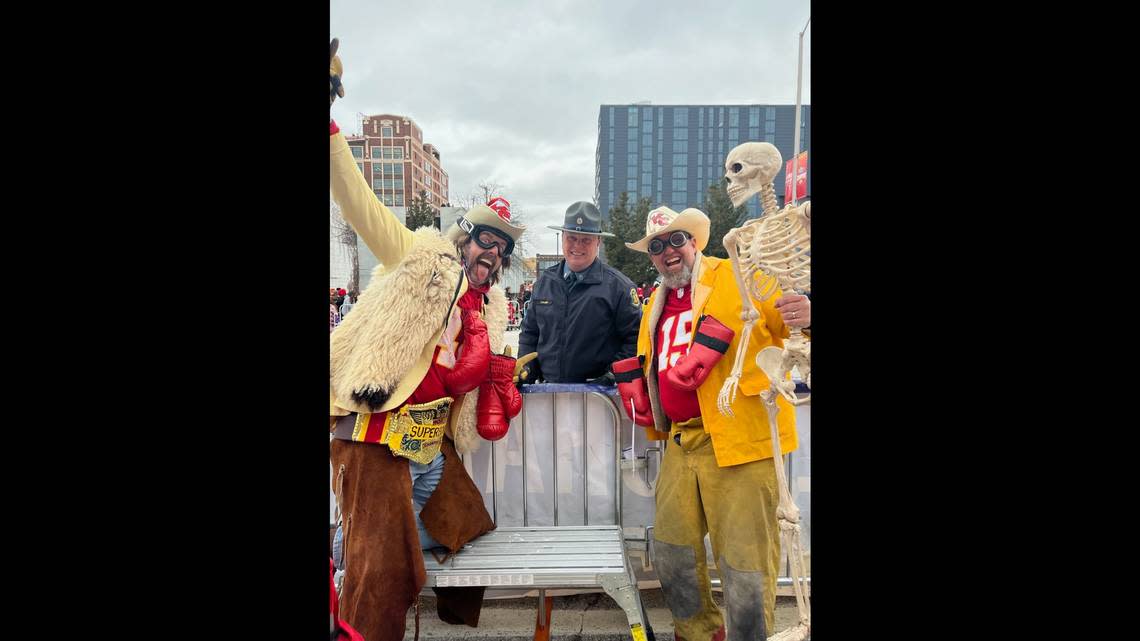 Grant Mong, Missouri Highway Patrol Trooper Clump and Casey Kapple pose for a photo with “Bones,” a skeleton owned by Clifton Alexander at the Chiefs Super Bowl Parade on Wed. Feb. 15, 2023.