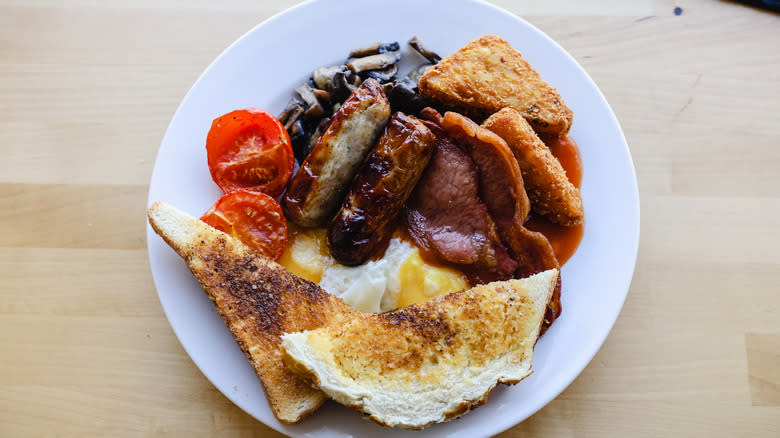 English breakfast with meat, eggs, toast