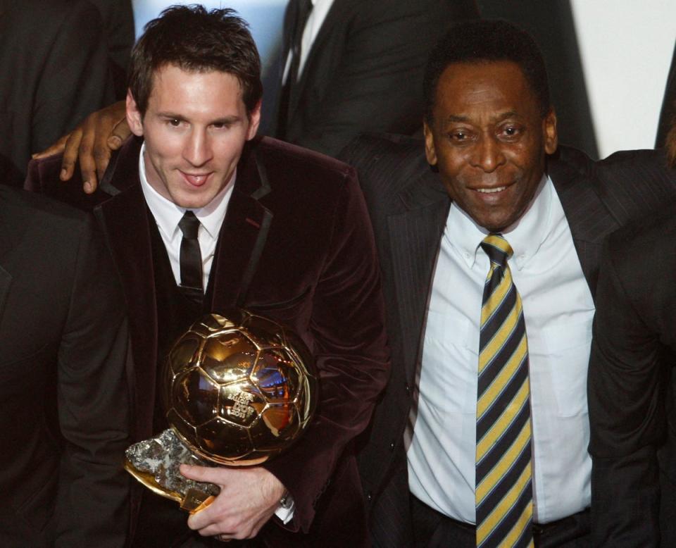 Lionel Messi holds the Ballon d’Or 2011 trophy next to Pele during the awards ceremony in Zurich (Reuters)