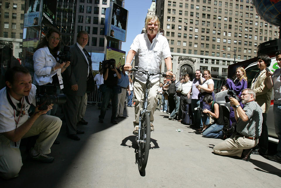 Sir Richard Branson rides a new invention called the 'StairCycle' during a press conference June 23, 2005 in New York City. Branson judged an invention contest which was won by the 