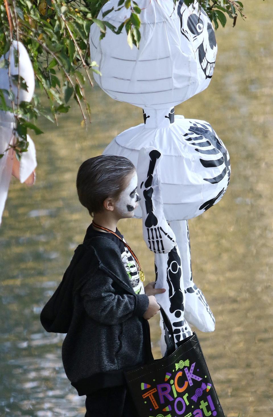 Dyson Duffy, 5, poses next to a skeleton that mirrors his own costume Saturday, Oct. 15, 2022, during Alliance City Parks' Fall Festival at Silver Park.