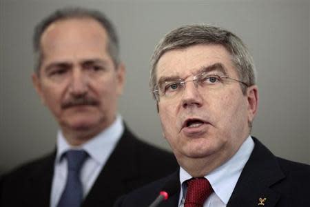 International Olympic Committee (IOC) President Thomas Bach (R) speaks during a news conference next to Brazil's Sports Minister Aldo Rebelo (L) after a meeting with Brazil's President Dilma Rousseff at the Planalto Palace in Brasilia January 21, 2014. REUTERS/Ueslei Marcelino