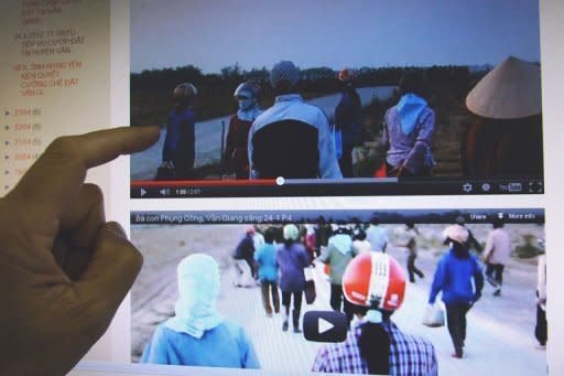 A man watches a video posted on the blog of Dr. Nguyen Xuan Dien showing villagers challenging policemen during forced land evictions in Van Giang district in April 2012. Authoritarian Vietnam is drafting a new decree on online content in a bid to clamp down on the country's blogosphere