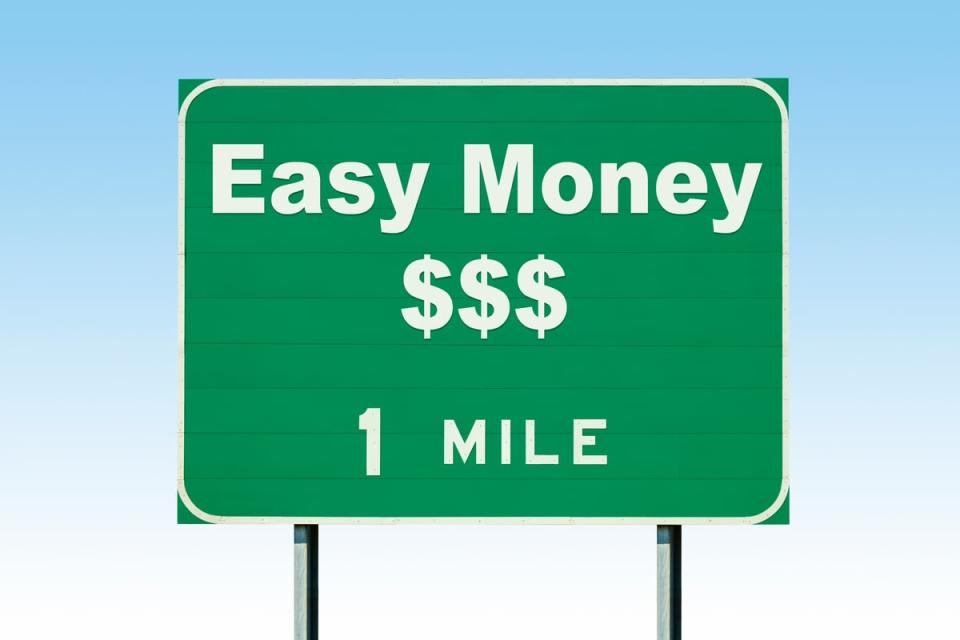 A road sign that says easy money 1 mile.