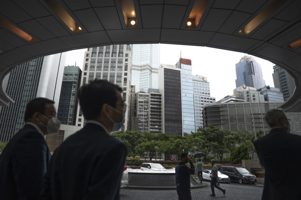 Guests leave from the Global Financial Leaders' Investment Summit in Hong Kong, Wednesday, Nov. 2, 2022. Severe tropical storm Nalgae edged closer to Hong Kong on Wednesday and forced businesses to close, but the finance summit that's meant to restore the city's image as an international financial hub pressed ahead. (AP Photo/Bertha Wang)