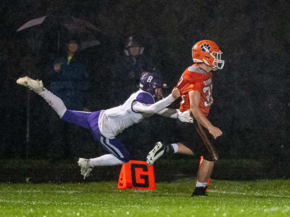 Dixon's Tyson Dambman unsuccessfully tries to stop Byron's Caden Considine on a touchdown run in the first quarter of their game against Dixon on Friday, Oct. 13, 2023, in Byron.