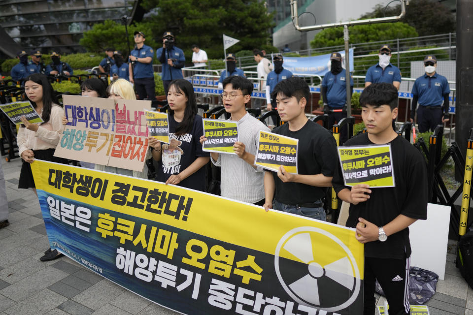 Students hold signs during a rally to oppose Japanese government's plan to release treated radioactive water into the sea from the Fukushima nuclear power plant, in Seoul, South Korea, Wednesday, July 5, 2023. The letters read "Stop to release radioactive water into ocean." (AP Photo/Lee Jin-man)