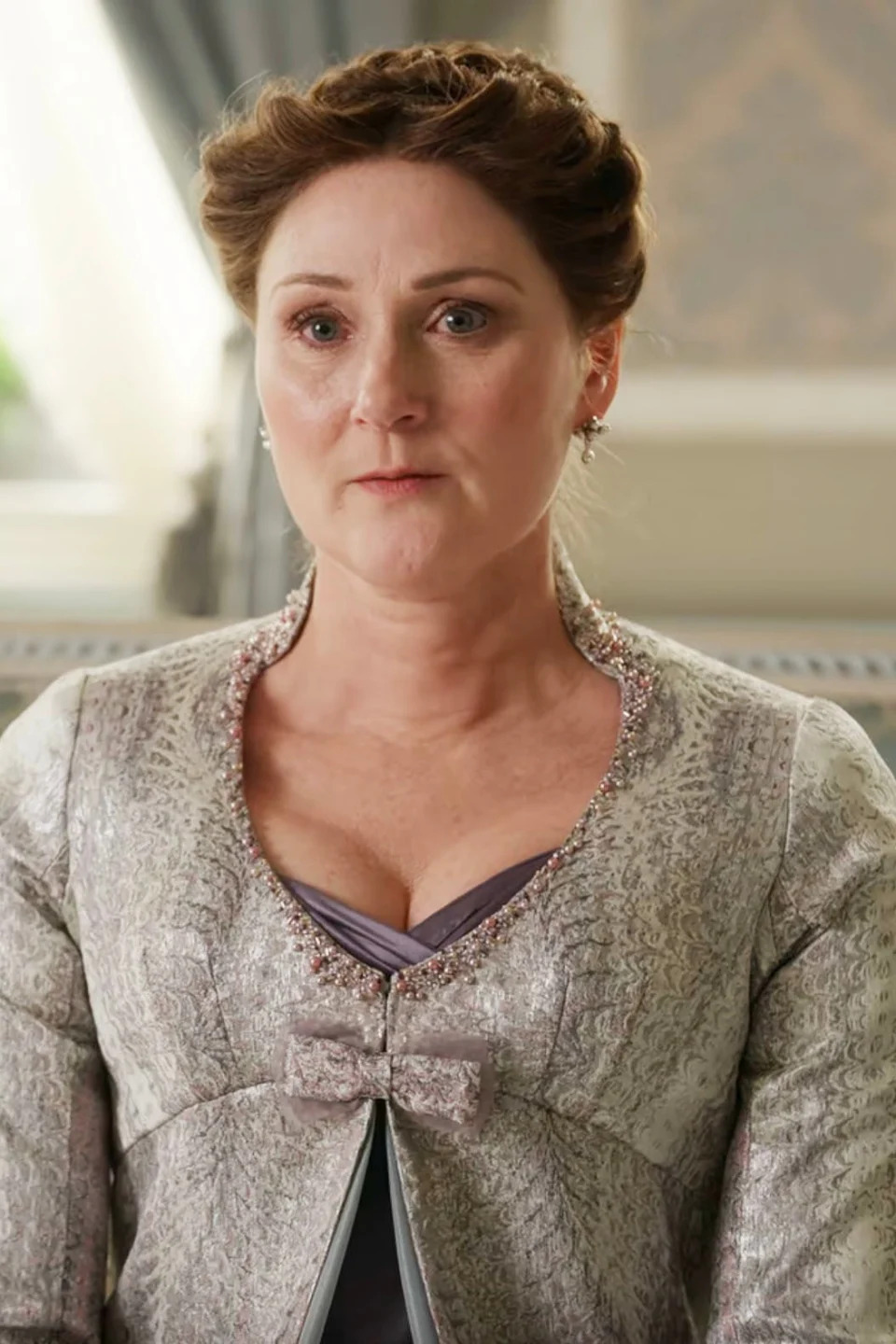 Lady Bridgerton, portrayed by Ruth Gemmell, in an elegant period costume with intricate detailing