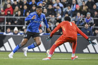 CF Montreal's Mason Toye, left, gets by Orlando City goalkeeper Pedro Gallese to score during the first half of an MLS soccer match Saturday, April 20, 2024, in Montreal. (Graham Hughes/The Canadian Press via AP)