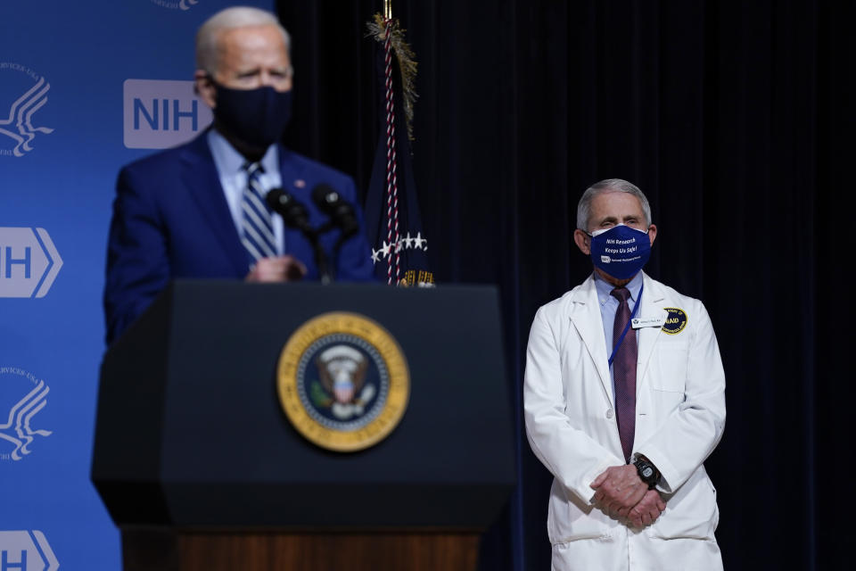 President Joe Biden speaks during a visit to the Viral Pathogenesis Laboratory at the National Institutes of Health, Thursday, Feb. 11, 2021, in Bethesda, Md. Dr. Anthony Fauci, director of the National Institute of Allergy and Infectious Diseases, listens at right. (AP Photo/Evan Vucci)