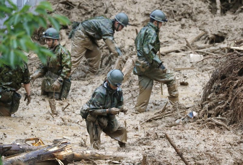 Japan Self-Defense Force soldiers search missing people at a landslide site caused by a heavy rain in Tsunagi town