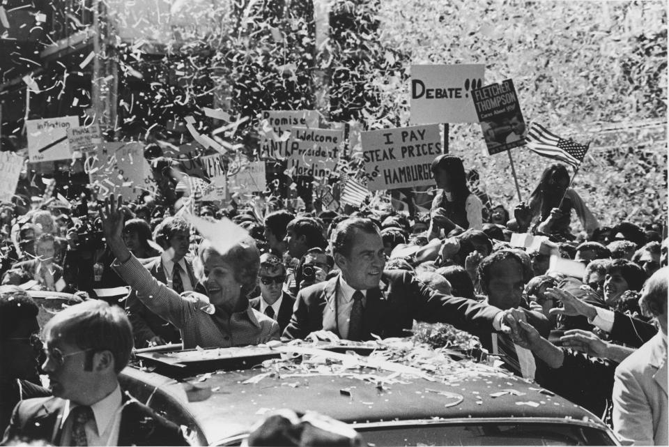 FILE - President Richard Nixon and first lady Pat Nixon are showered with ticker tape as they wave from the rooftop of their motorcade during a parade up Peachtree Street in Atlanta, Ga., Oct. 12, 1972, during his re-election campaign tour. Nixon, a Republican, defeated George McGovern, a Democrat, in a landslide. (AP Photo, File)