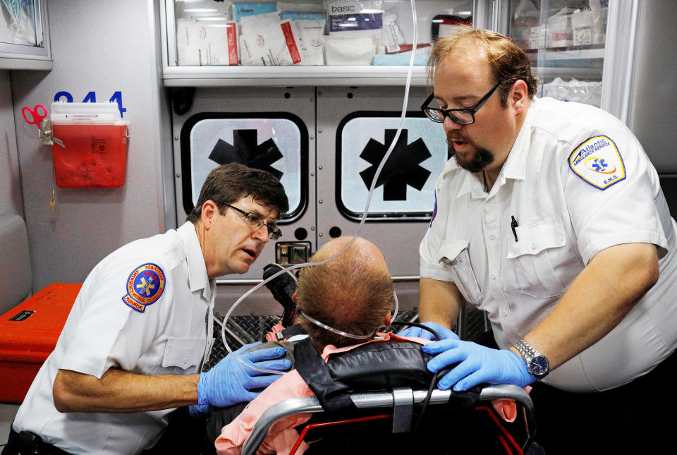 Image: Medics care for a man who was found unresponsive after overdosing on an opioid in the Boston suburb of Salem, Mass., on Aug. 9, 2017. (Brian Snyder / Reuters file)