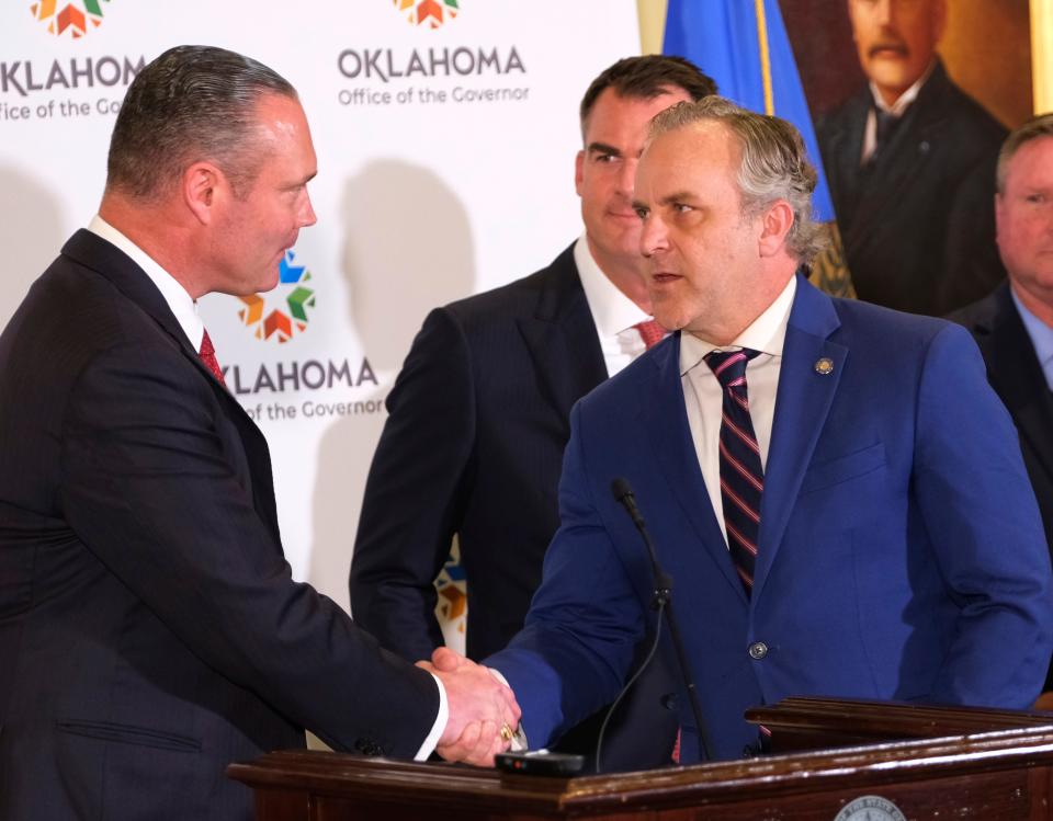 House Speaker Charles McCall welcomes Senate President Pro Tem Greg Treat to the podium Monday as Gov. Kevin Stitt looks on. The leaders, along with other members from the House and Senate, announced a historic education reform agreement in the Blue Room of the state Capitol.