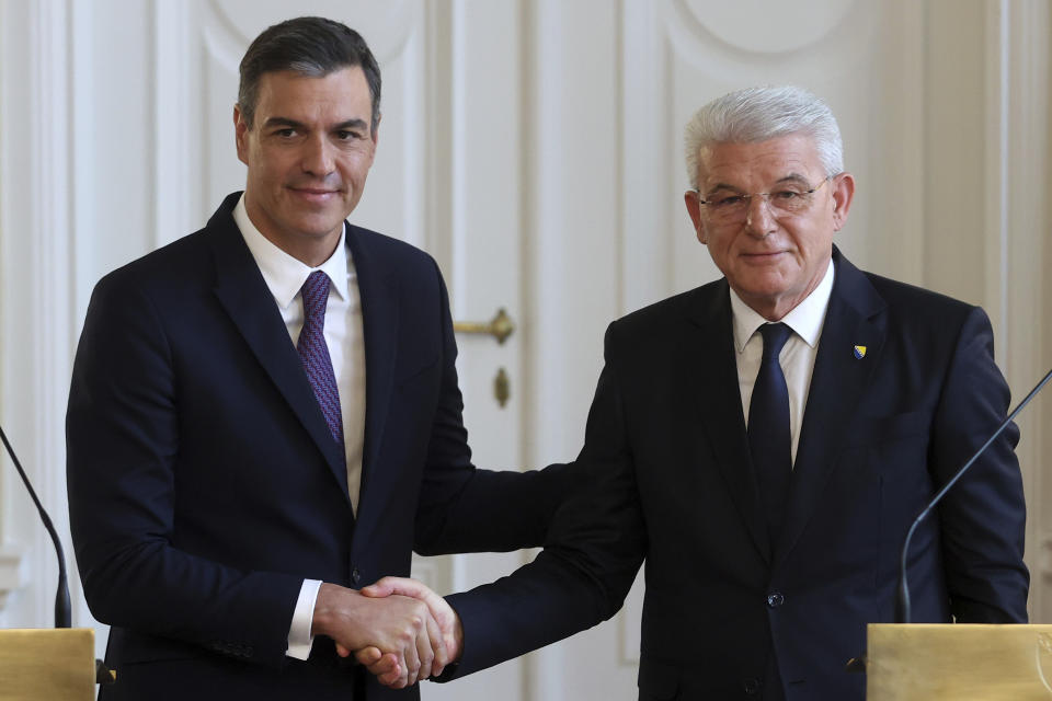 Spanish Prime Minister Pedro Sanchez, left, shakes hands with the member of the Bosnian presidency Sefik Dzaferovic after a press conference in Sarajevo, Bosnia, Saturday, July 30, 2022. (AP Photo/Armin Durgut)