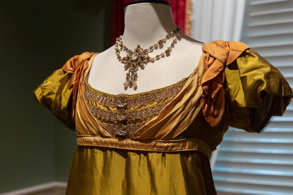 A view of the silk evening dress and pearl-embellished necklace worn by Anna Chancellor as Miss Caroline Bingley in the 1995 adaptation of "Pride and Prejudice" pictured on Thursday, June 9, 2022. Jane Austen: Fashion & Sensibility, a collection of costumes from eight acclaimed film adaptations of Jane Austen's classic novels, is on display at Taft Museum of Art through Sept. 4.
