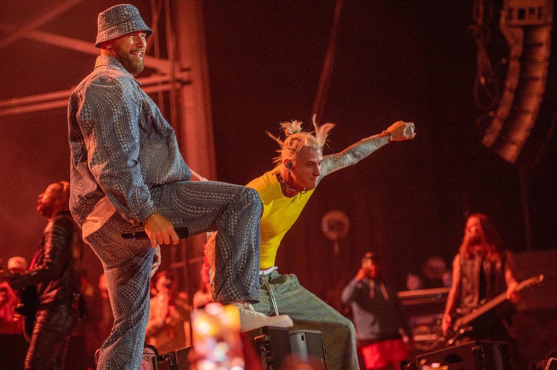 Travis Kelce, left, and Machine Gun Kelly rock out to the Beastie Boys’ “Fight for Your Right” at Kelce Jam at the Azura Amphitheater on Friday. Emily Curiel/ecuriel@kcstar.com