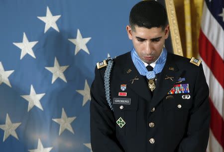 Retired U.S. Army Captain Florent "Flo" Groberg bows his head in the East Room of the White House after being awarded the Medal of Honor by U.S. President Barack Obama (not pictured) in Washington November 12, 2015. REUTERS/Gary Cameron