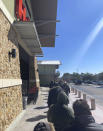 This photo provided by Rodney Giles people wait on line to enter a H-E-B grocery store on Tuesday, Feb. 17, 2021 near Woodlands, Texas. A series of winter storms and widespread power outages gripping Texas and other states not used to such extreme low temperatures are creating big challenges in the nation’s food supply networks. (Rodney Giles via AP)