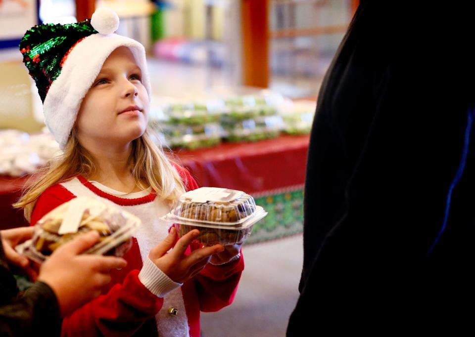 Brooke Babich carries her cookies to checkout at a previous Redeemer United Church of Christ Christmas Cookie Sale.