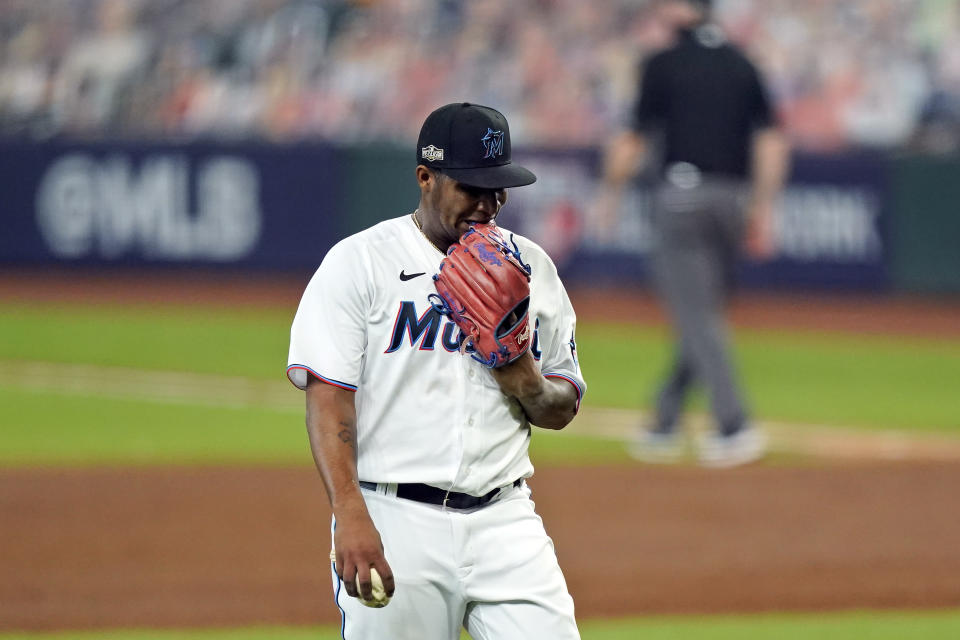 Miami Marlins starting pitcher Sixto Sanchez bites his glove as he walks off they field after the final out in the third inning in Game 3 of a baseball National League Division Series against the Atlanta Braves, Thursday, Oct. 8, 2020, in Houston. (AP Photo/David J. Phillip)