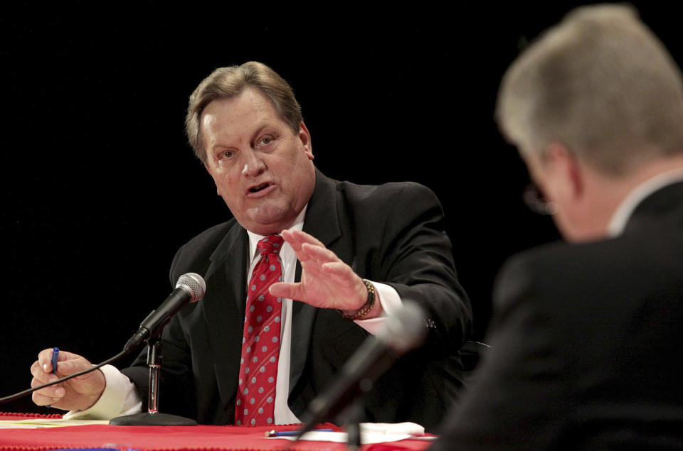 FILE - GOP candidates, U.S. Rep. Mike Simpson, left, debates challenger Bryan Smith at Canyon Ridge High School, Friday, April 25, 2014, in Twin Falls, Idaho. Simpson is running for reelection to Idaho's 2nd Congressional District in the Nov. 8, 2022 election.(Ashley Smith/Times-News via AP, File)