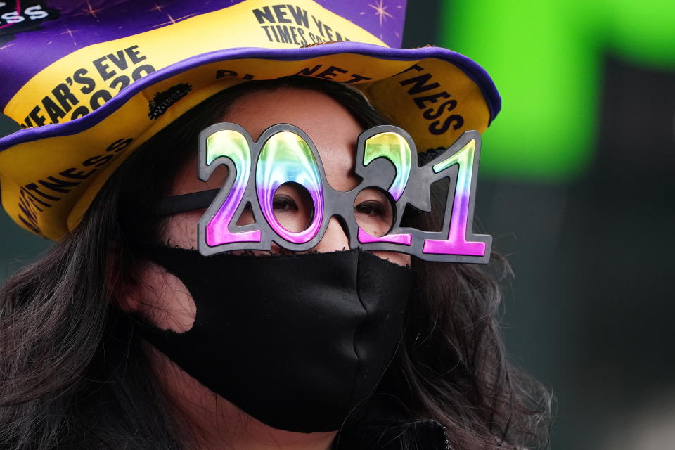 A woman wears '2021' numeral glasses in advance of New Year's eve in Times Square amid the coronavirus disease (COVID-19) pandemic in the Manhattan borough of New York City, New York, U.S., December 21, 2020. REUTERS/Carlo Allegri