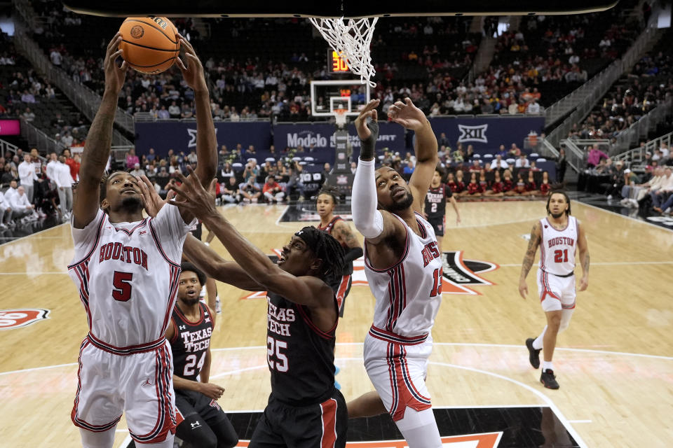 Houston forward Ja'Vier Francis (5) beats Texas Tech forward Robert Jennings (25) to a rebound during the first half of an NCAA college basketball game in the semifinal round of the Big 12 Conference tournament, Friday, March 15, 2024, in Kansas City, Mo. (AP Photo/Charlie Riedel)