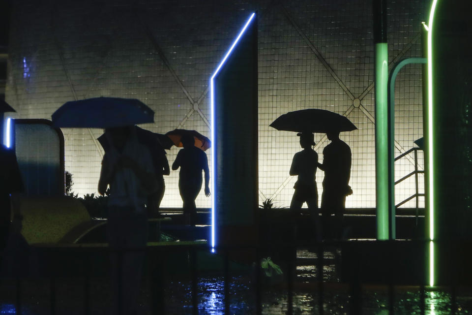 Residents walk with umbrellas as typhoon Saola hits Hong Kong, on Friday, Sept. 1, 2023. Most of Hong Kong and other parts of southern China ground to a near standstill Friday with classes and flights canceled as powerful Typhoon Saola approached. (AP Photo/Daniel Ceng)