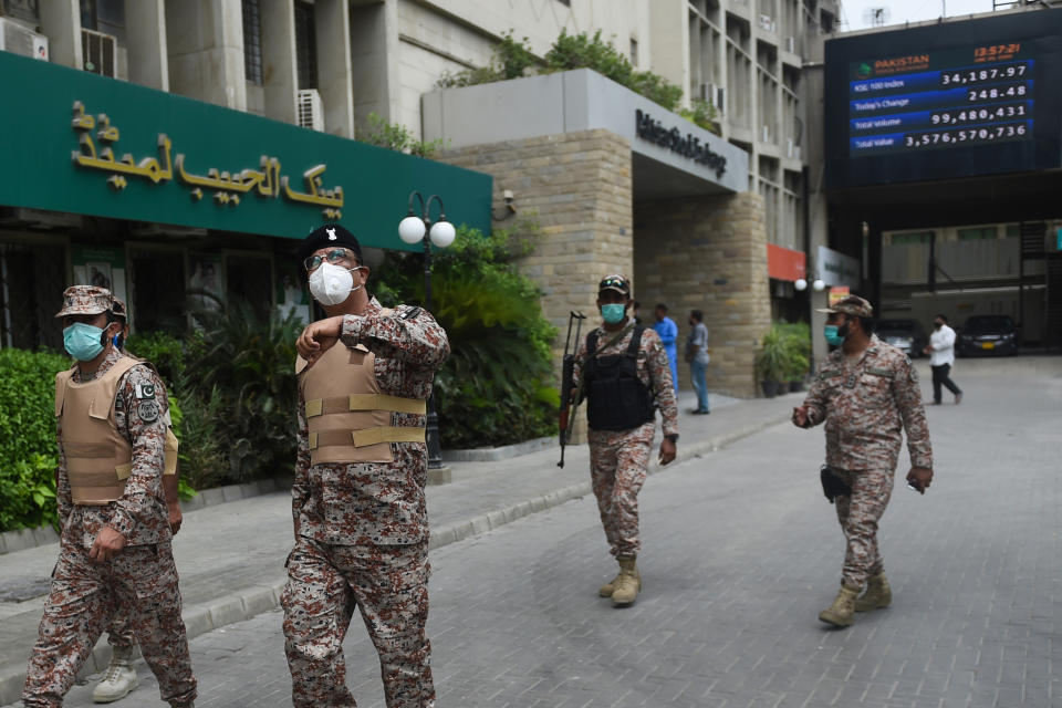 Paramilitary officers inspect the premises of the Pakistan Stock Exchange building following an attack by gunmen in Karachi on June 29, 2020. (Photo by RIZWAN TABASSUM/AFP via Getty Images)