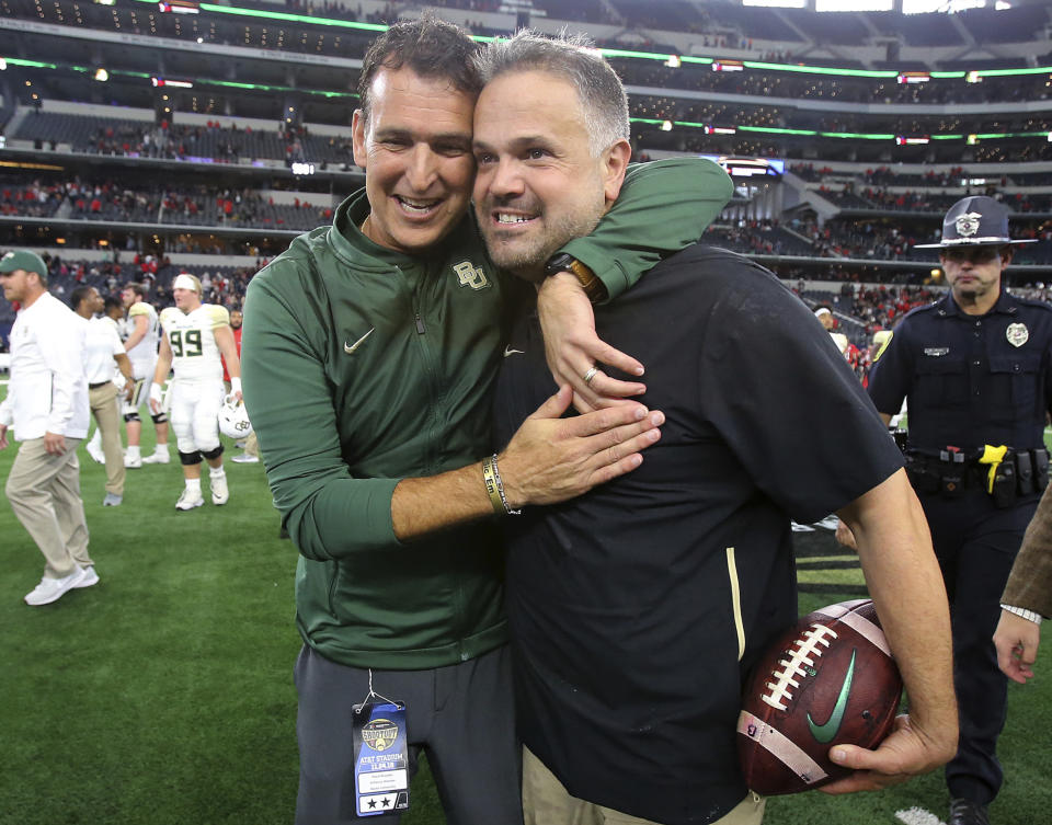FILE - In this Nov. 24, 2018, file photo, Baylor athletic director Mack Rhoades, left, congratulates head coach Matt Rhule after defeating Texas Tech in an NCAA college football game, in Arlington, Texas. A person familiar with the situation says the Carolina Panthers are completing a contract to hire Baylor's Matt Rhule as their coach. The person spoke to The Associated Press on Tuesday, Jan. 7, 2020, on condition of anonymity because the deal is not done. The Panthers have not spoken publicly about the coaching search. (Jerry Larson/Waco Tribune-Herald via AP, File)