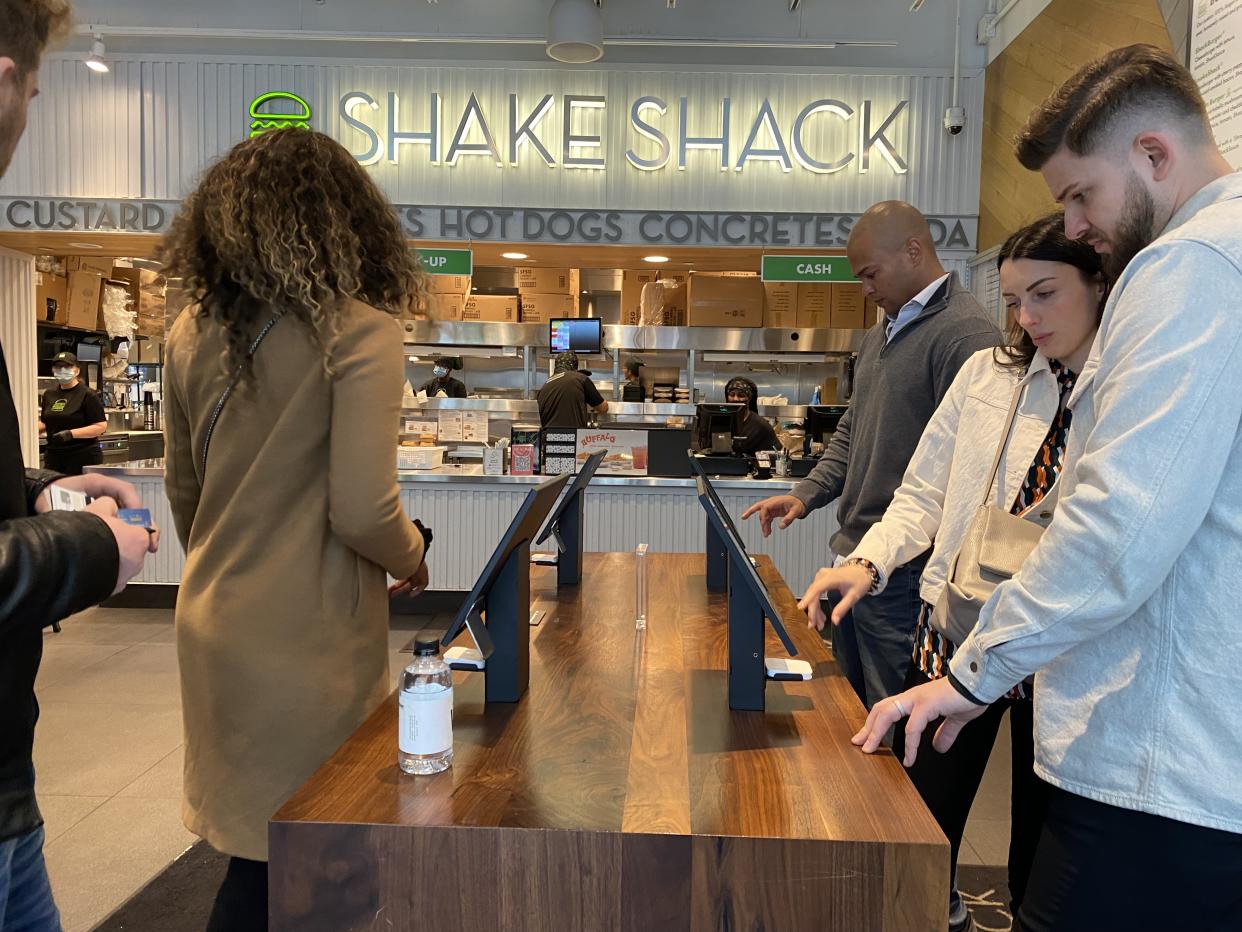 Customers using Shake Shack self service ordering kiosks, Queens, New York. (Photo by: Lindsey Nicholson/UCG/Universal Images Group via Getty Images)