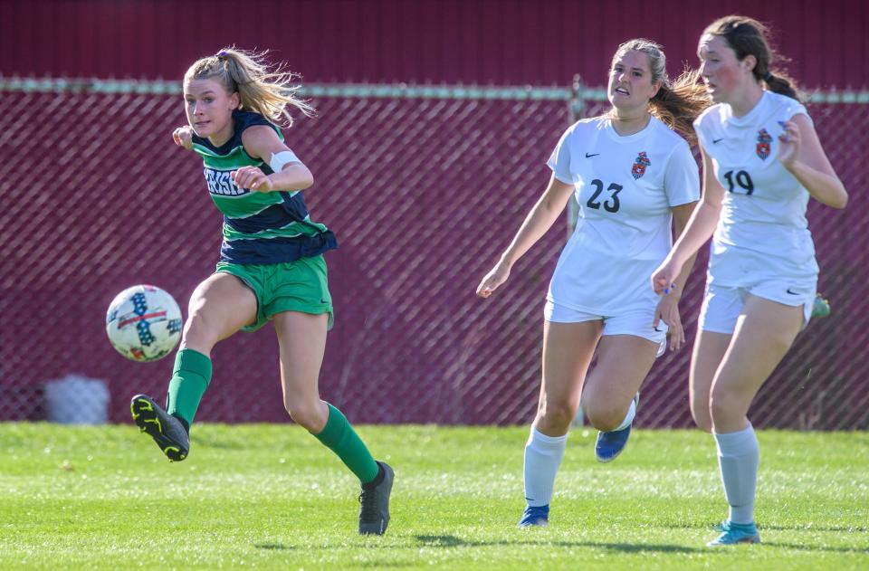 Peoria Notre Dame's Mya Wardle, left, gets past Normal Community's Lindsey Leverton (23) and Emma Henry (19) for a shot in the first period Thursday, April 13, 2023 at PND High School. The Irish blanked the Ironmen 2-0.