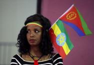 A woman wears the Ethiopian and Eritrean national flags during a concert at the Millennium Hall in Addis Ababa, Ethiopia July 15, 2018. REUTERS/Tiksa Negeri