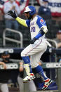 Atlanta Braves' Marcell Ozuna (20) gestures as he rounds third base after hitting a two-run home run during the first inning of the team's baseball game against the Miami Marlins on Tuesday, April 13, 2021, in Atlanta. (AP Photo/John Bazemore)