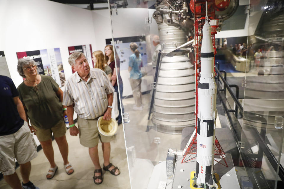 Visitors look onto a scale model of the Saturn V rocket used in the United State's Apollo program at the Armstrong Air and Space Museum as special events are underway for visitors commemorating the 50th anniversary of the first moon landing, Saturday, July 20, 2019, in Wapakoneta, Ohio. (AP Photo/John Minchillo)