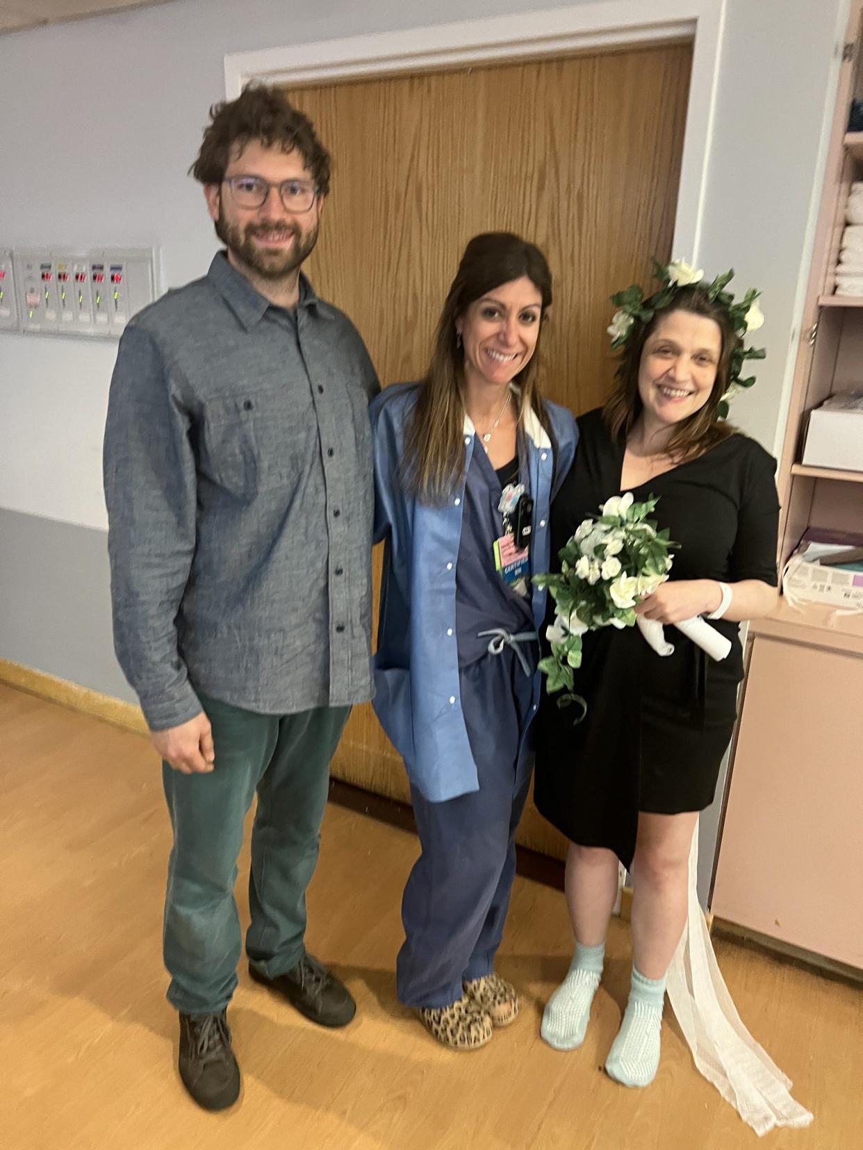 Newlyweds and new parents Michael and Nora stand with nurse Valerie Goodwin on their wedding day at Northern Westchester Hospital.