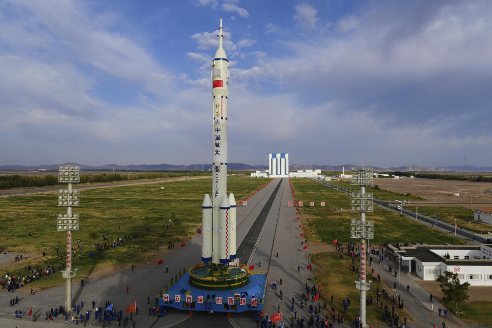In this photo released by Xinhua News Agency, the Shenzhou-13 manned spaceship atop a Long March-2F carrier rocket is transferred to the launching area of Jiuquan Satellite Launch Center in northwestern China, Oct. 7, 2021. China is preparing to send three astronauts to live on its space station for six months — a new milestone for a program that has advanced rapidly in recent years. (Wang Jiangbo/Xinhua via AP)