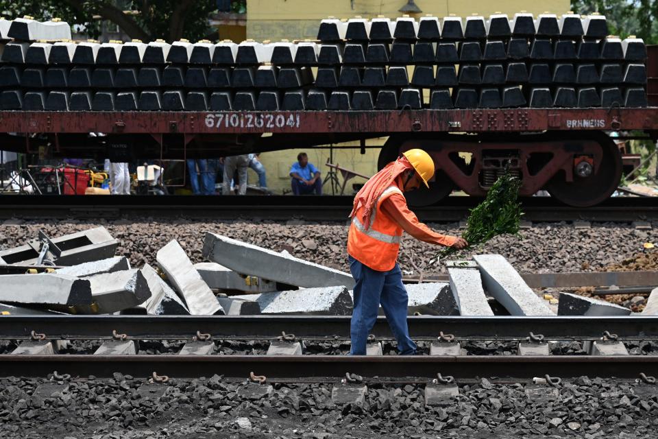 A worker inspects the newly-reopened track at the scene of a three-train collision near Balasore, 125 miles from the state capital Bhubaneswar in the eastern state of Odisha, June 5, 2023. / Credit: PUNIT PARANJPE/AFP/Getty