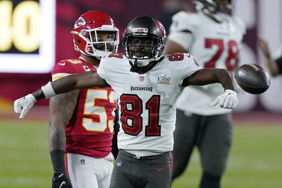 FILE - Tampa Bay Buccaneers wide receiver Antonio Brown reacts after making a catch against the Kansas City Chiefs during the first half of the NFL Super Bowl 55 football game in Tampa, Fla., in this Sunday, Feb. 7, 2021, file photo. Receiver Antonio Brown has agreed to return to the Tampa Bay Buccaneers on a one-year contract that could be worth up to $6.5 million, including incentives, a person familiar with the deal told The Associated Press. The person spoke on the condition of anonymity Wednesday, April 28, 2021, because the agreement, which includes a $2 million signing bonus and a little more than $3 million guaranteed, had not been announced by the reigning Super Bowl champions. (AP Photo/Mark Humphrey, File)