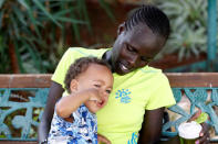 Lonah Chemtai, a Kenyan-born runner who will represent Israel in the women's marathon at the 2016 Rio Olympics, looks at her 19 month-old son, Roy Salpeter, after training with her husband and coach, Israeli Dan Salpeter, near their house in Moshav Yanuv, central Israel July 14, 2016. REUTERS/Baz Ratner