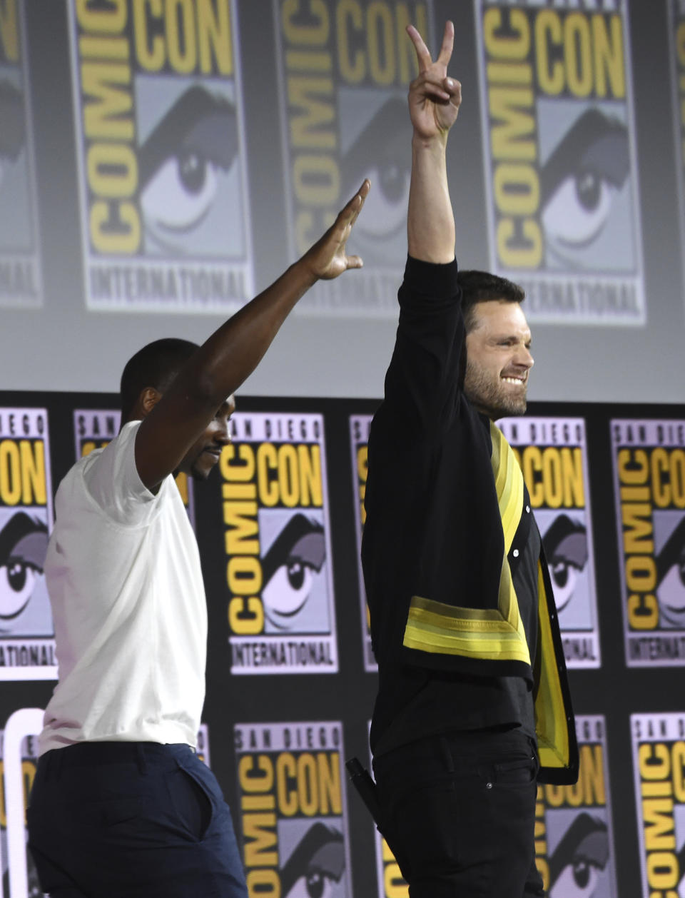 Sebastian Stan, left, and Anthony Mackie gesture to the audience at the Marvel Studios panel on day three of Comic-Con International on Saturday, July 20, 2019, in San Diego. (Photo by Chris Pizzello/Invision/AP)