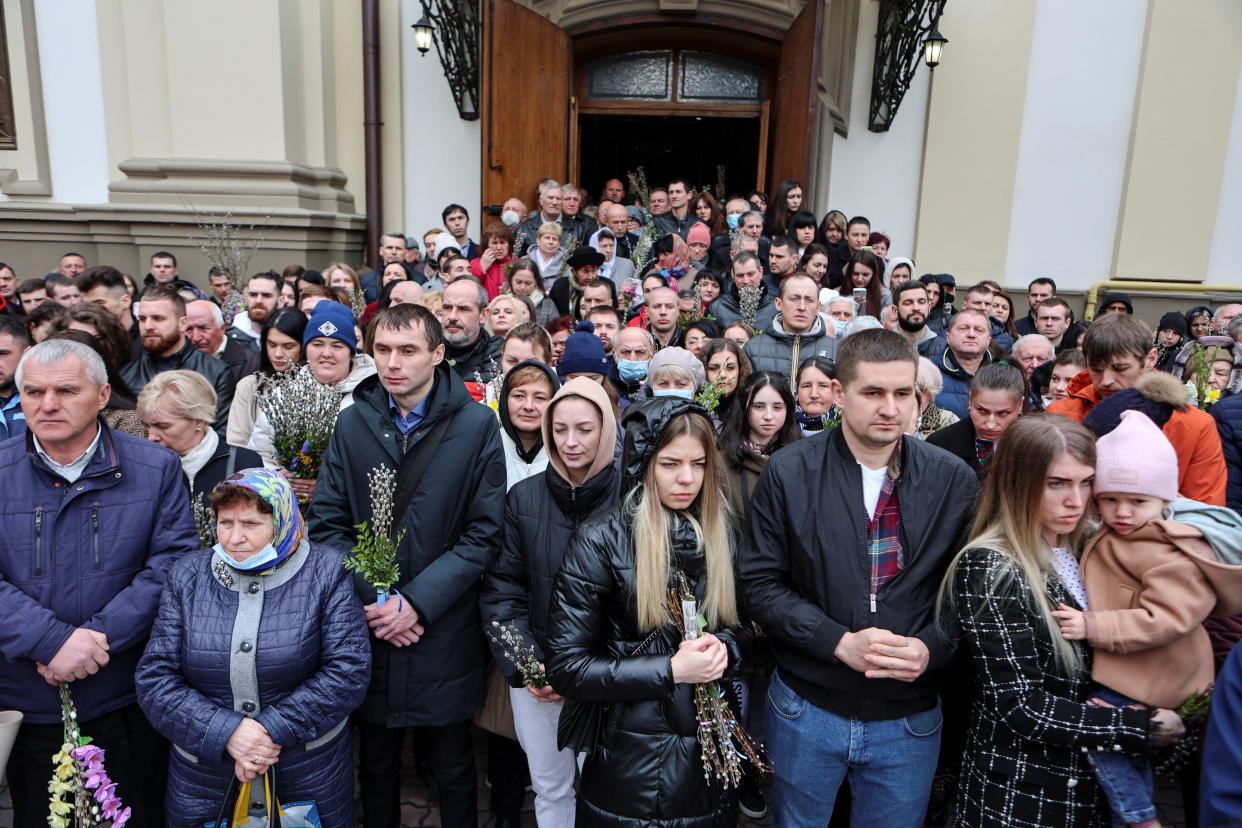 People hold willow branches as they celebrate Orthodox Palm Sunday.