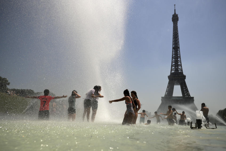 Youngsters cool off at the Trocadero public fountain in Paris, Wednesday, June 26, 2019. High temperatures are expected to go up to 39 degrees Celsius (102 Fahrenheit) in the Paris area later this week and bake much of the country, from the Pyrenees in the southwest to the German border in the northeast. (AP Photo/Francisco Seco)