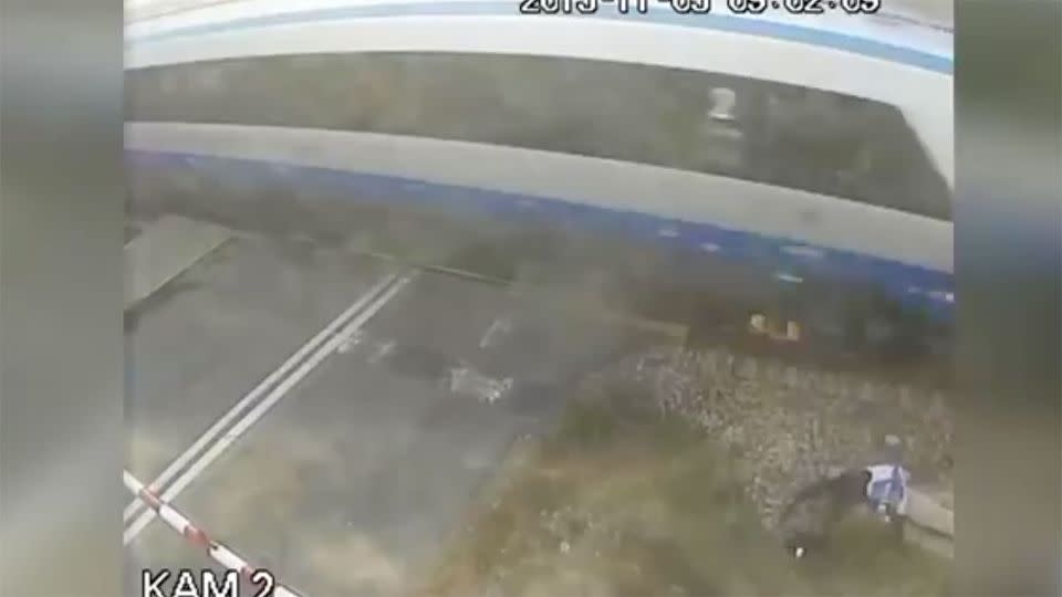 The cyclist's body lies motionless just metres from the point of contact with the train. Photo: screenshot/Youtube