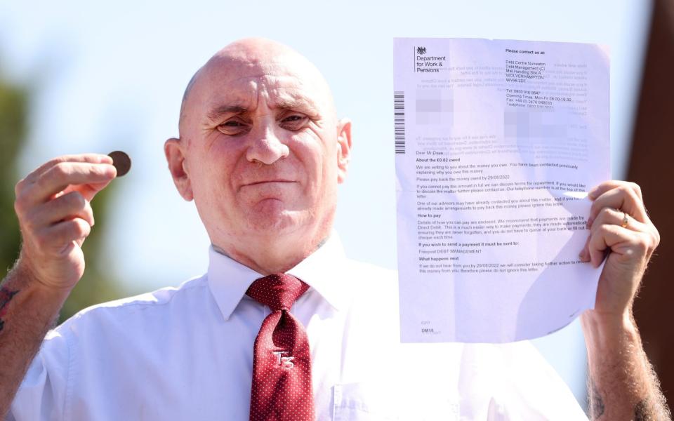 Damien Dove with a DWP letter demanding he repay a 2p debt - Iain Buist/NCJ Media