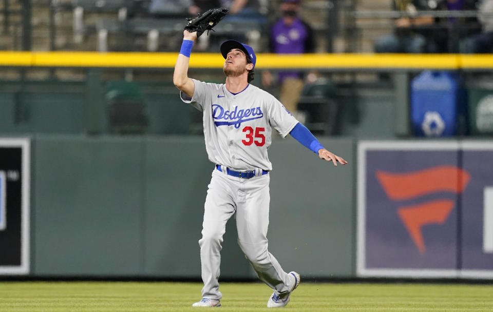 Los Angeles Dodgers center fielder Cody Bellinger pulls in a shallow fly ball off the bat of Colorado Rockies' Chris Owings for the final out in the ninth inning of a baseball game Saturday, April 3, 2021, in Denver. (AP Photo/David Zalubowski)