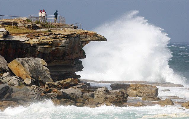 A wave crashes onto rocks at Sunday's Bondi Beach, New South Wales. AP Photo / Rick Rycroft