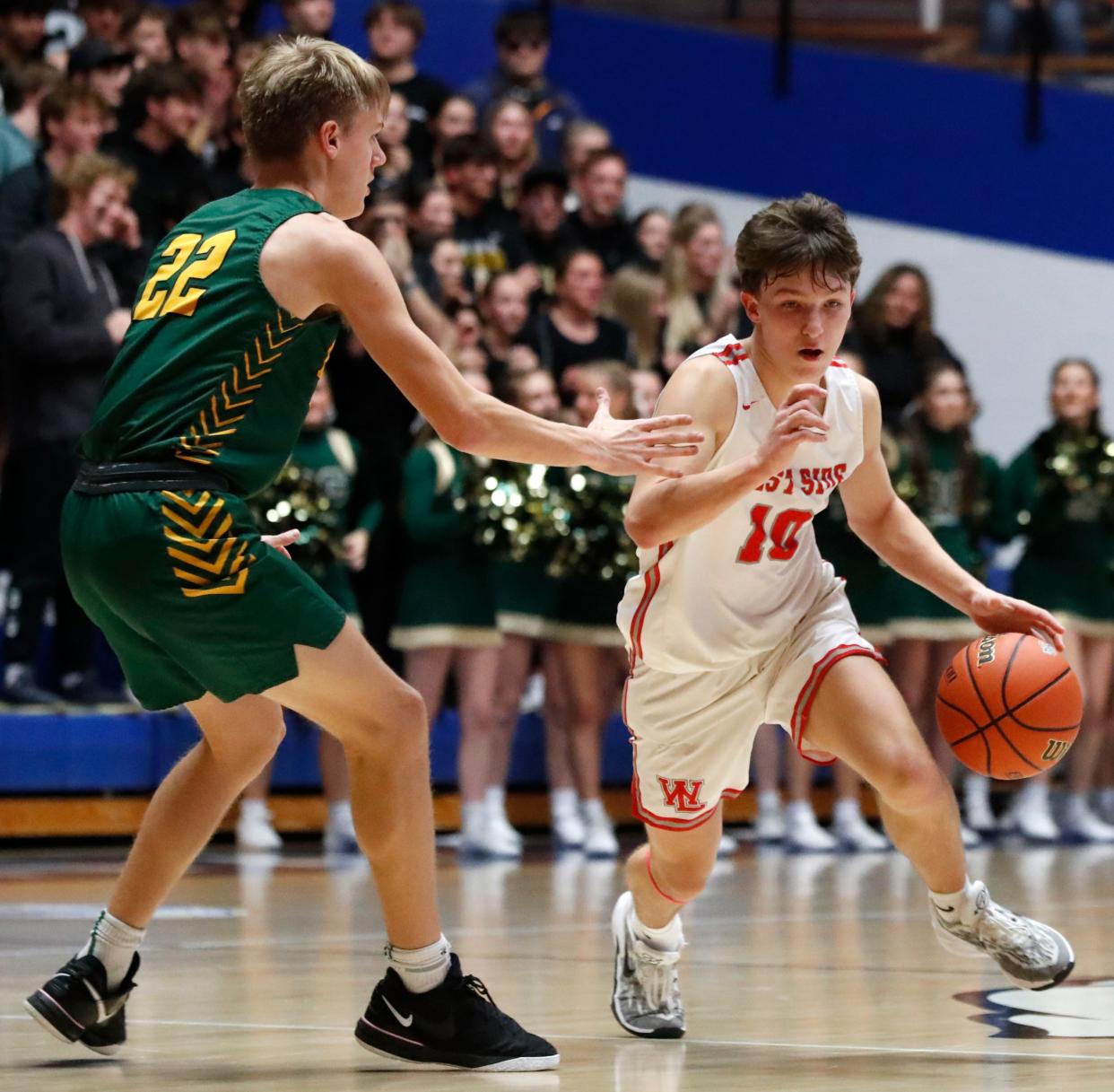 Benton Central Bison Chase Brummett (22) defends West Lafayette Red Devils Ben Werth (10) during the IHSAA boy’s basketball sectional game, Wednesday, Feb. 28, 2024, at Frankfort High School in Frankfort, Ind. West Lafayette Red Devils won 41-40.