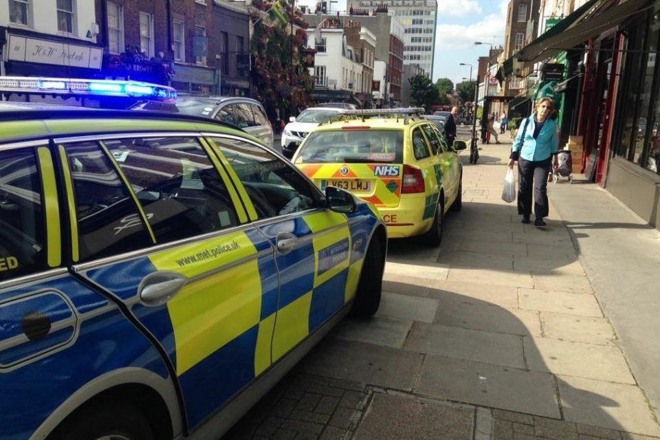 Police and paramedics parked up on Kensington Church Street.